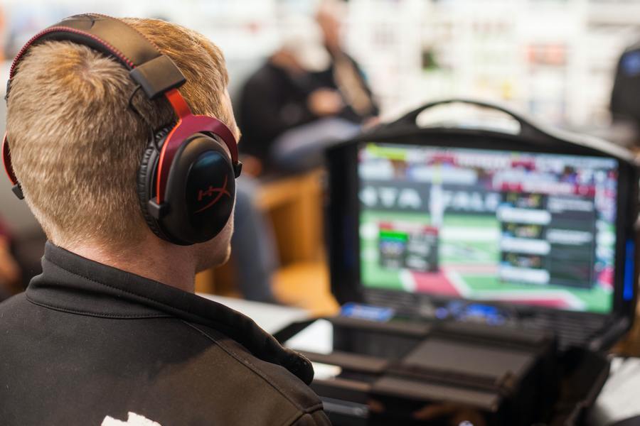 Man with headphones on looking at computer