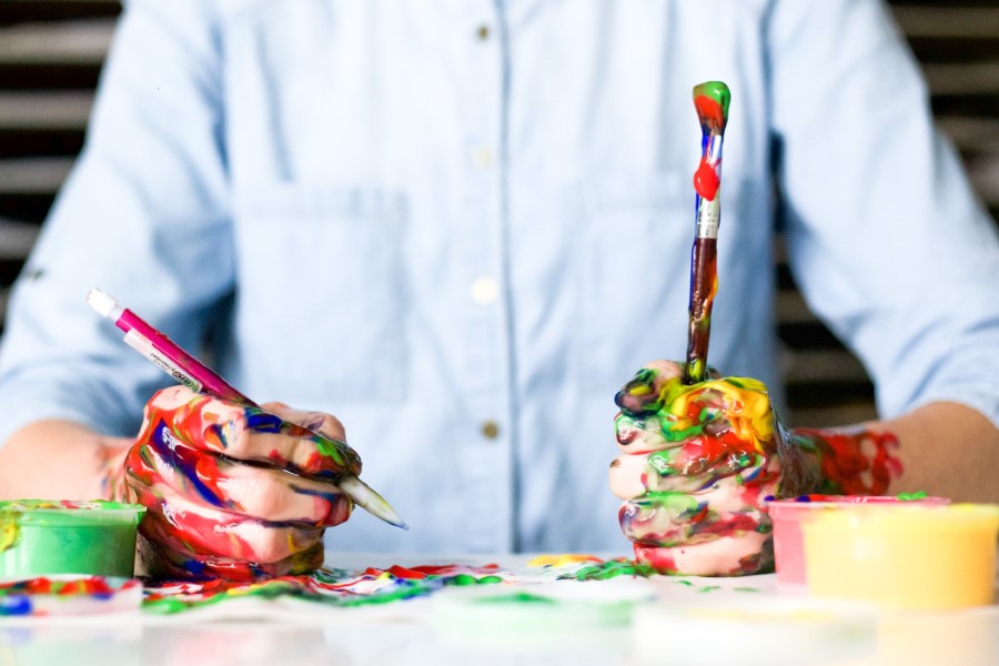 man painting with messy fingers