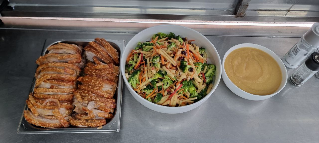 photo_2024-10-01_12-54-52 Three dishes at Deskplex Office Space Hawthorn Richmond Abbotsford: a tray of sliced roasted pork, a large bowl of mixed vegetables, and a bowl of yellowish puree or sauce.
