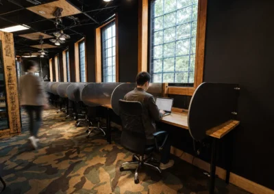 Hot desk coworking area at DeskPlex Hawthorn with individual workstations and natural light