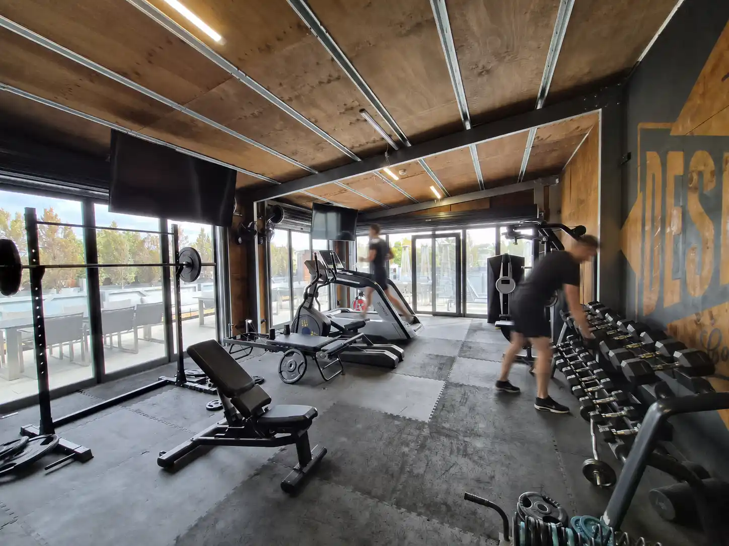 On-site gym at DeskPlex coworking space in Hawthorn with cardio equipment, weights and strength training facilities