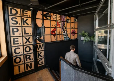 Distinctive interior at DeskPlex Hawthorn featuring custom artwork, industrial finishes and a bold contemporary design, creating a unique coworking and private office environment for businesses near Richmond, Abbotsford and Melbourne CBD.