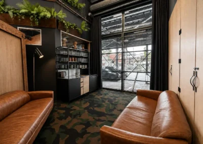 Private lounge and kitchenette area within the DeskPlex Executive Headquarters in Hawthorn, giving larger teams their own comfortable breakout space alongside dedicated workstations, meeting facilities and shared premium amenities.