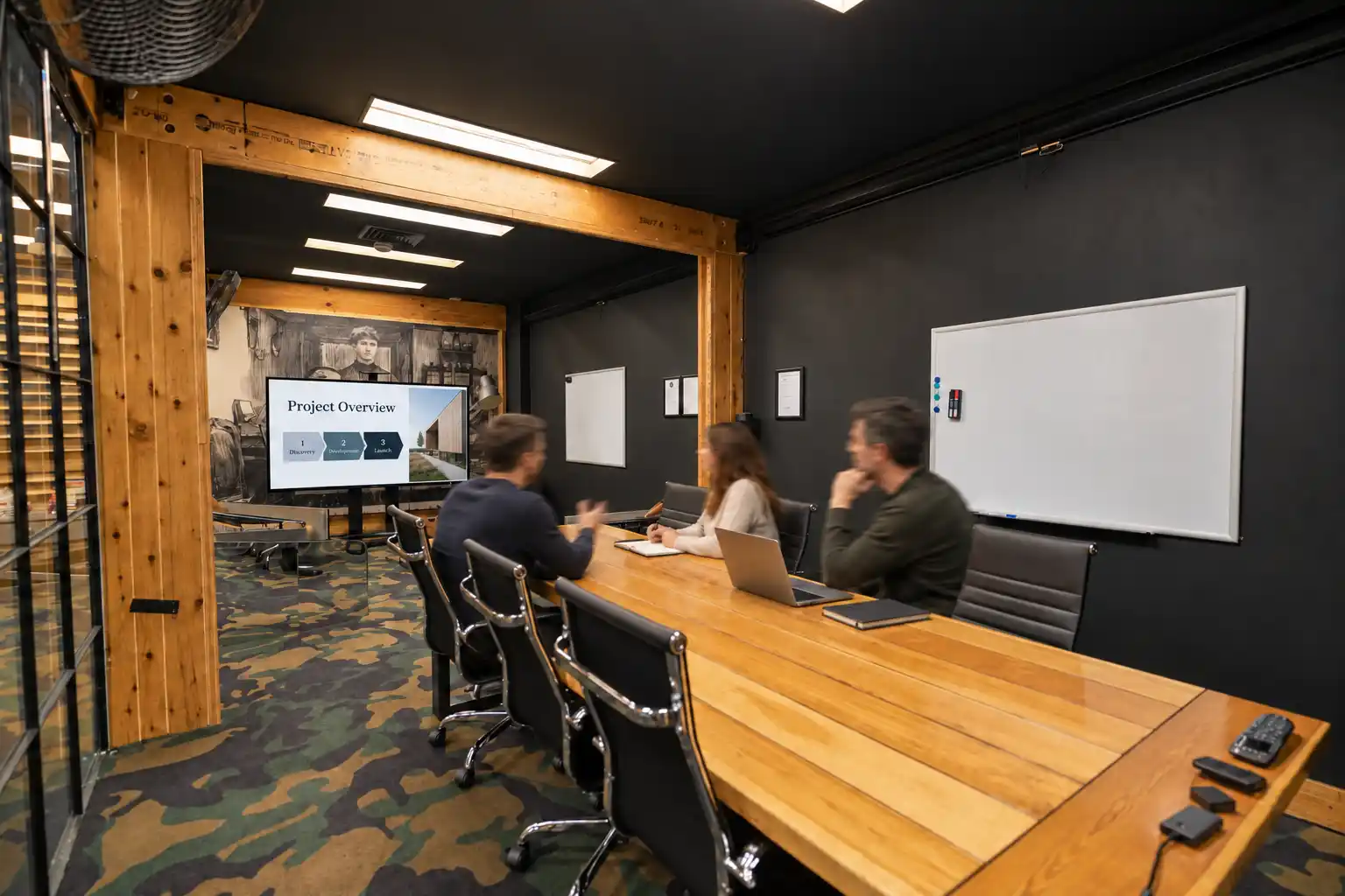 Large boardroom at DeskPlex Hawthorn with a long conference table, presentation screen and whiteboards, designed for team meetings, client presentations, workshops and collaborative sessions.